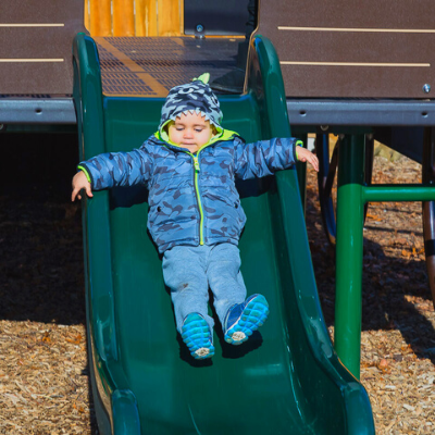 Kid on prairie wagon slide