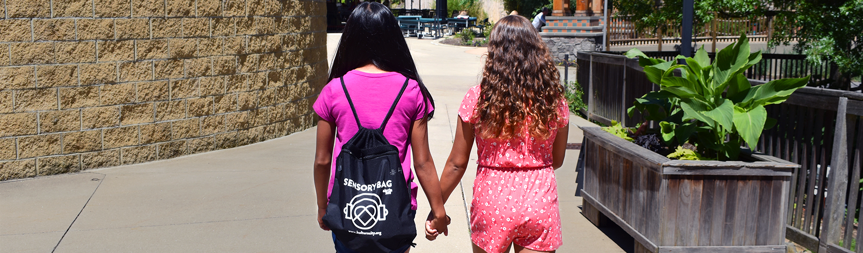 Two girls walking hand in hand