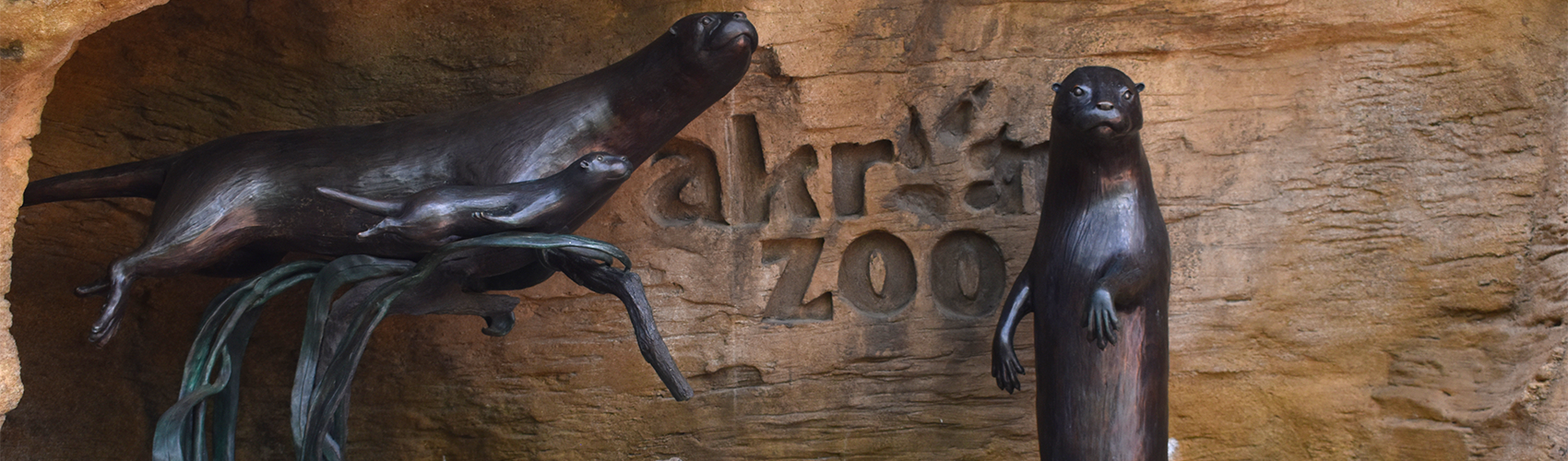 Statue of three otters at Akron Zoo