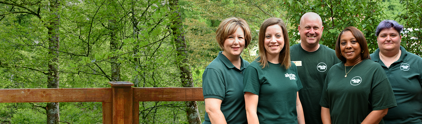 Group of Akron Zoo staff with a forest background