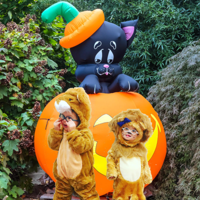 Children in costumes near Halloween inflatable
