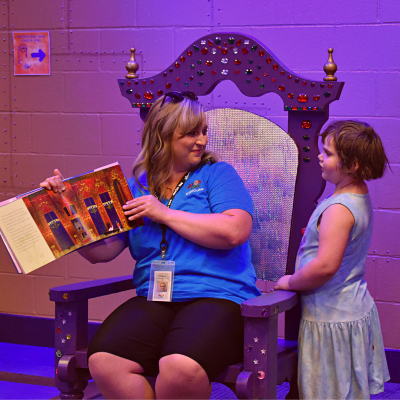 Zoo volunteer reading princess story to guests