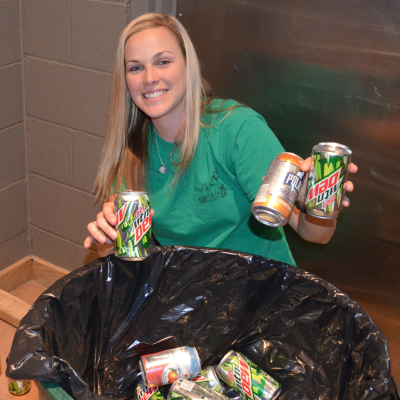 Woman recycling soda cans