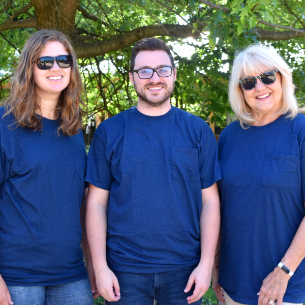 Two women and one man wearing blue