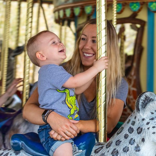 Mother and son on carousel