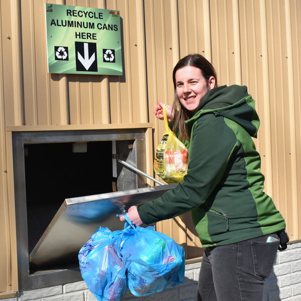 Woman recycling aluminum cans