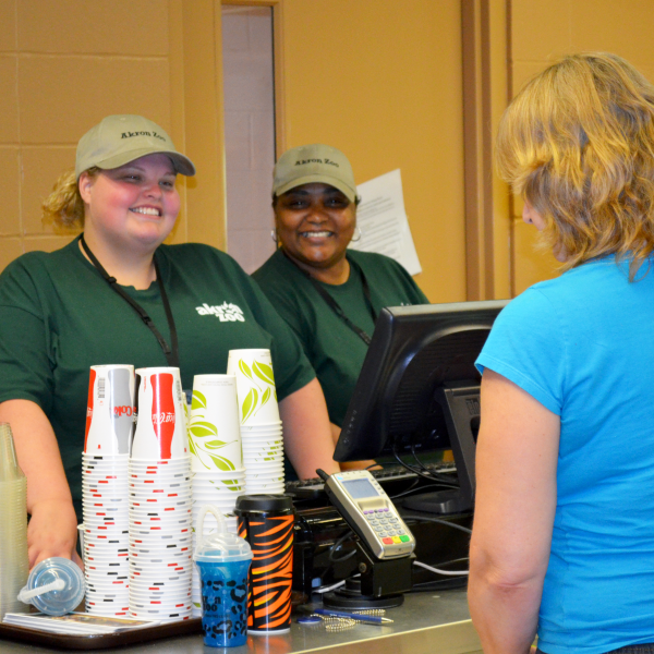 Employee with guests buying concessions